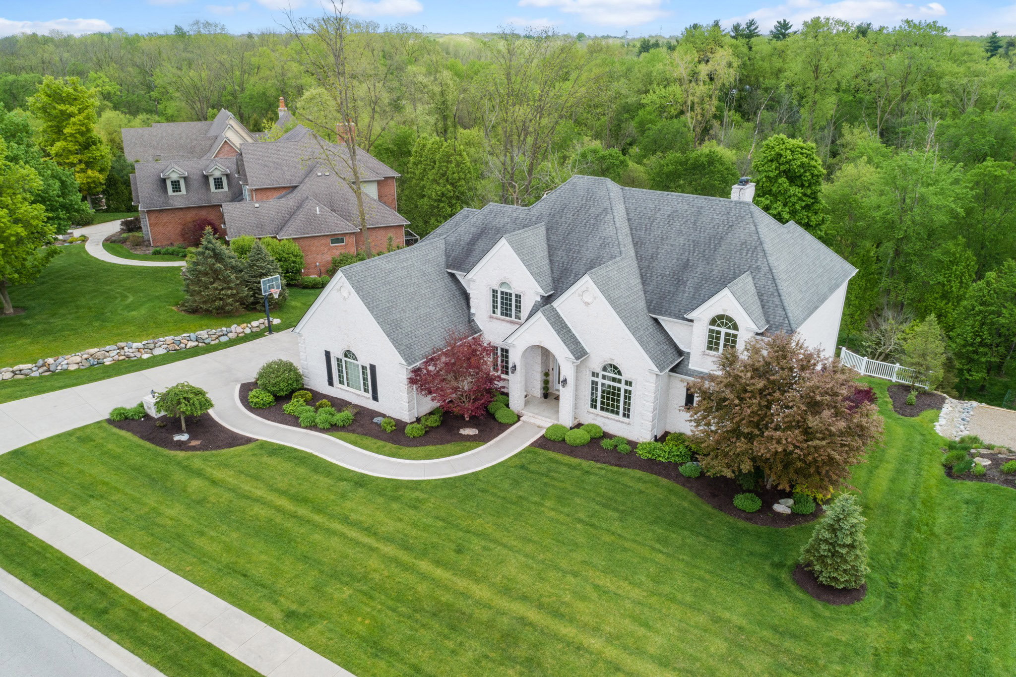 A white mansion with gray roof